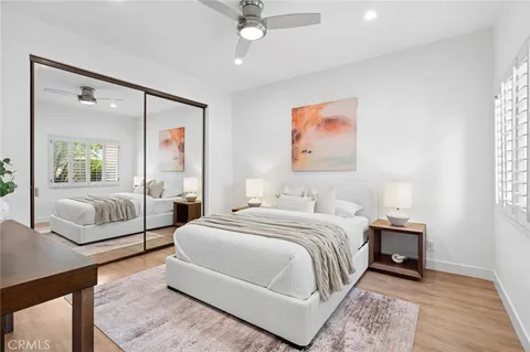 a bedroom with a large bed and a chandelier