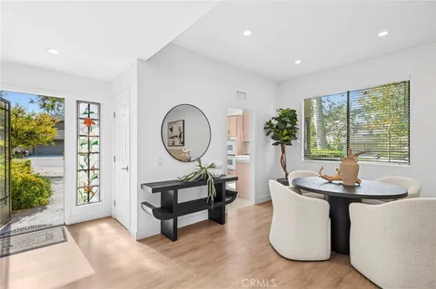 a living room with furniture a window and a potted plant