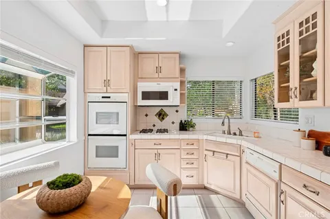 a kitchen with stainless steel appliances a stove a sink and cabinets