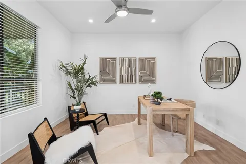 a dining room with furniture and a potted plant