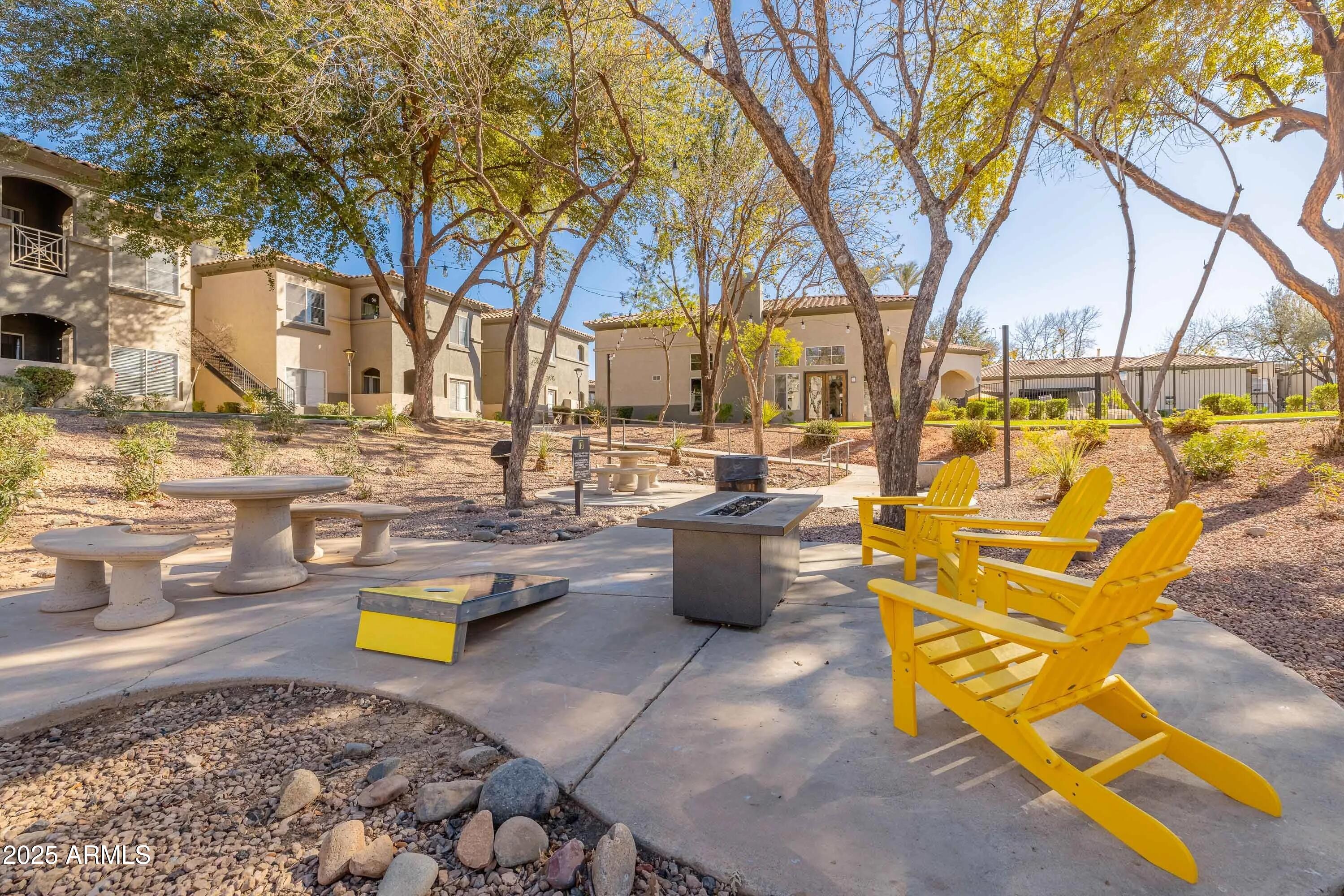 17374 North 89th Avenue, Unit C1 Peoria, AZ 85382 - Photo 20 of 22 a view of swimming pool with sitting area and fire pit