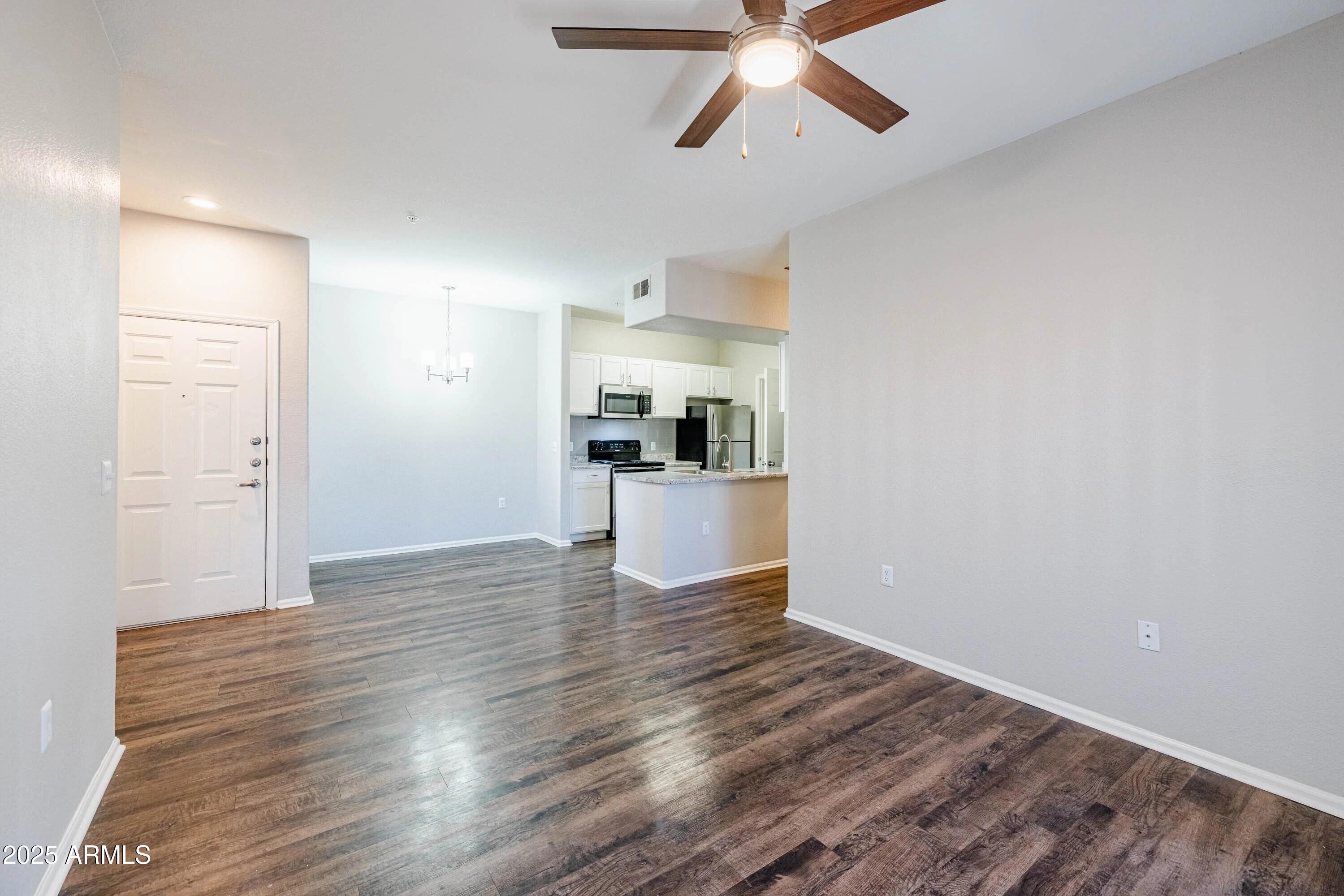 17374 North 89th Avenue, Unit C1 Peoria, AZ 85382 - Photo 4 of 22 a view of a kitchen with a sink and dishwasher with wooden floor