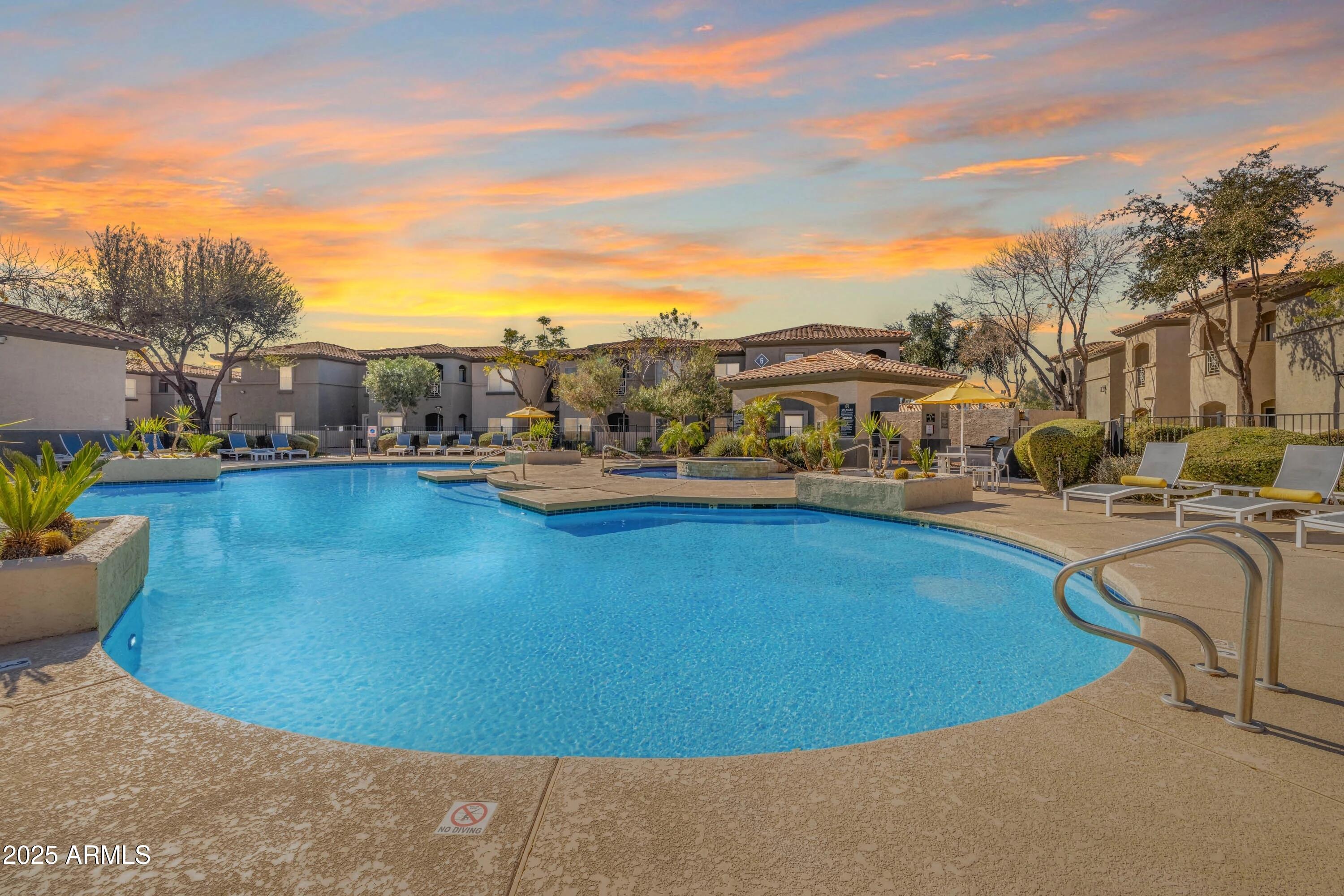 17374 North 89th Avenue, Unit C1 Peoria, AZ 85382 - Photo 8 of 22 a view of a swimming pool in front of residential houses