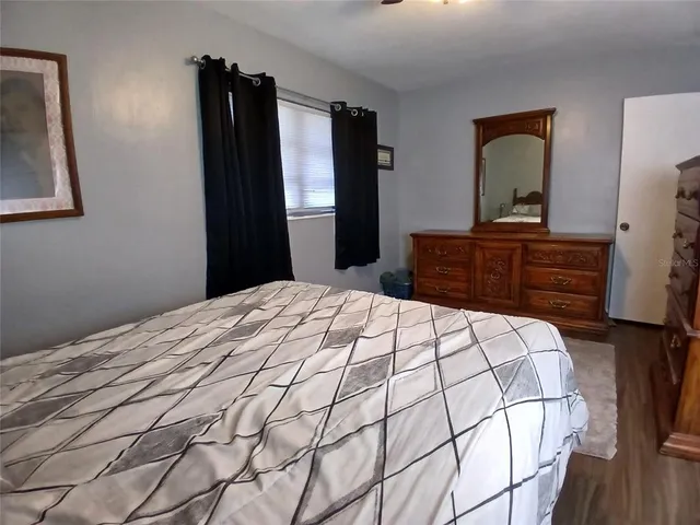 a bedroom with a bed and a dresser
