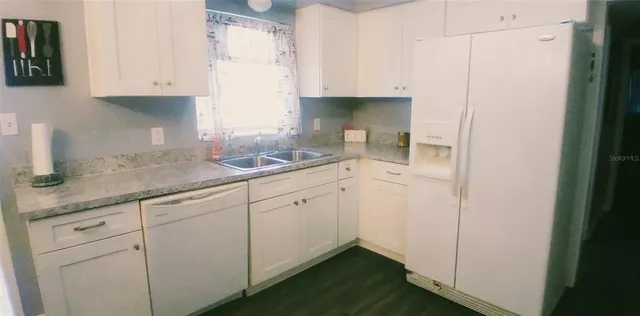 a kitchen with a sink and cabinets
