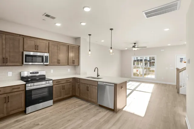 a kitchen with stainless steel appliances granite countertop a sink and stove top oven