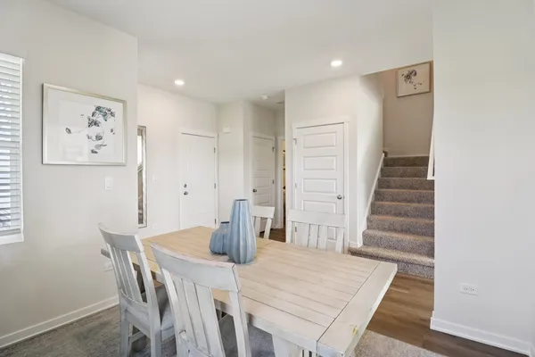 a view of a dining room with furniture and wooden floor