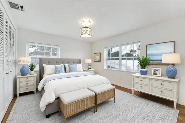 a spacious bedroom with a bed and a window