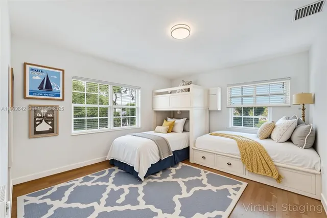 a bedroom with two beds and a window