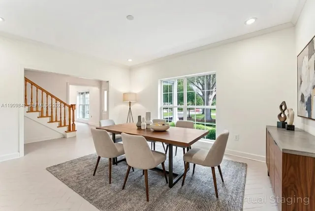 a view of a dining room with furniture and a potted plant