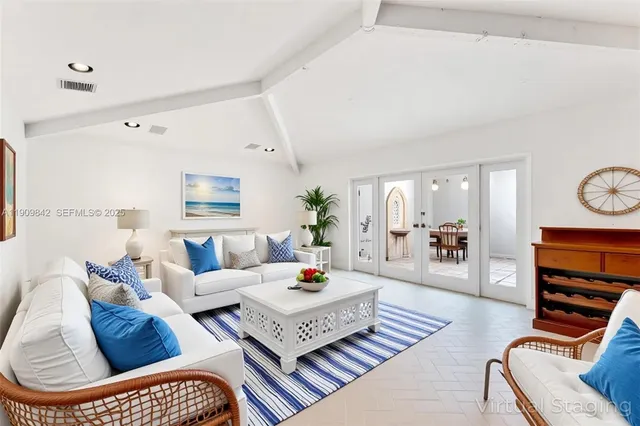 a living room with furniture a rug and a window