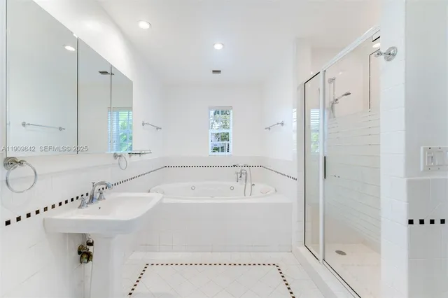 a bathroom with a sink a mirror and a bathtub