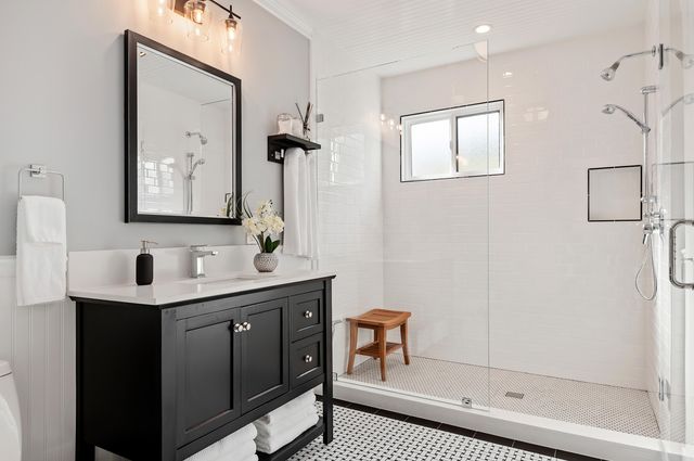 a bathroom with a shower sink and mirror