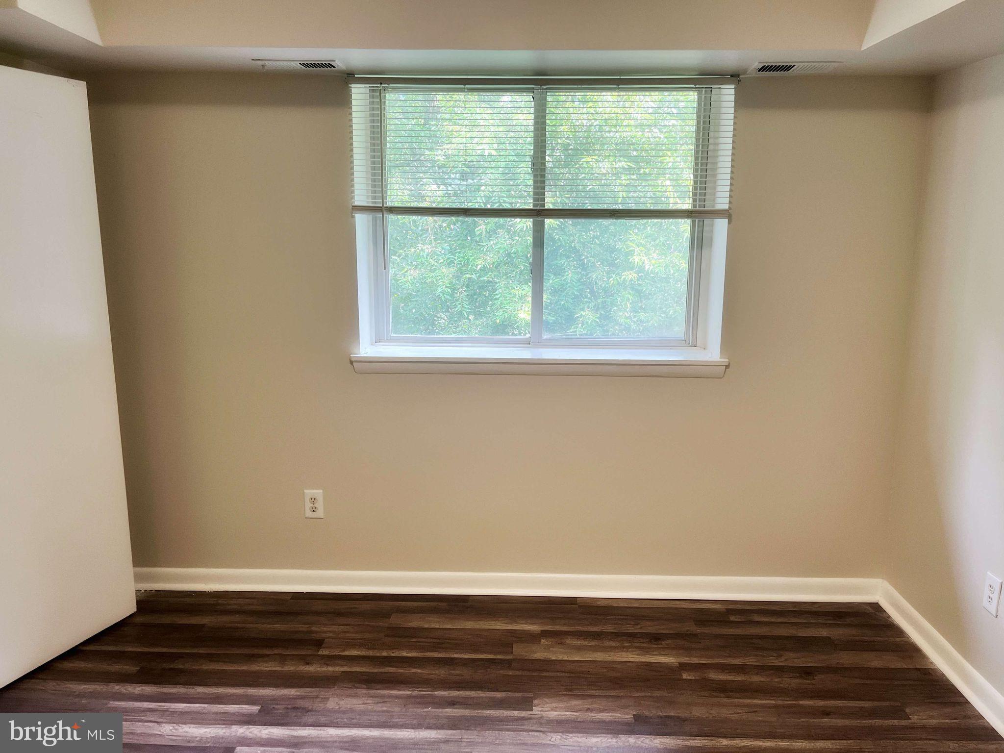 2656 Bowen Road Southeast, Unit 402 Washington, DC 20020 - Photo 8 of 10 a view of a room with wooden floor and a window