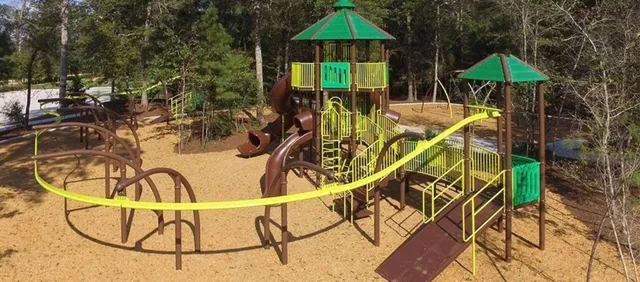 a view of a swimming pool with a table and chairs under an umbrella
