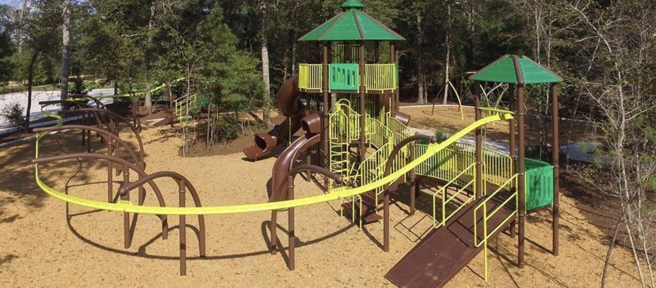20961 Zuccala Drive New Caney, TX 77357 - Photo 27 of 33 a view of a swimming pool with a table and chairs under an umbrella