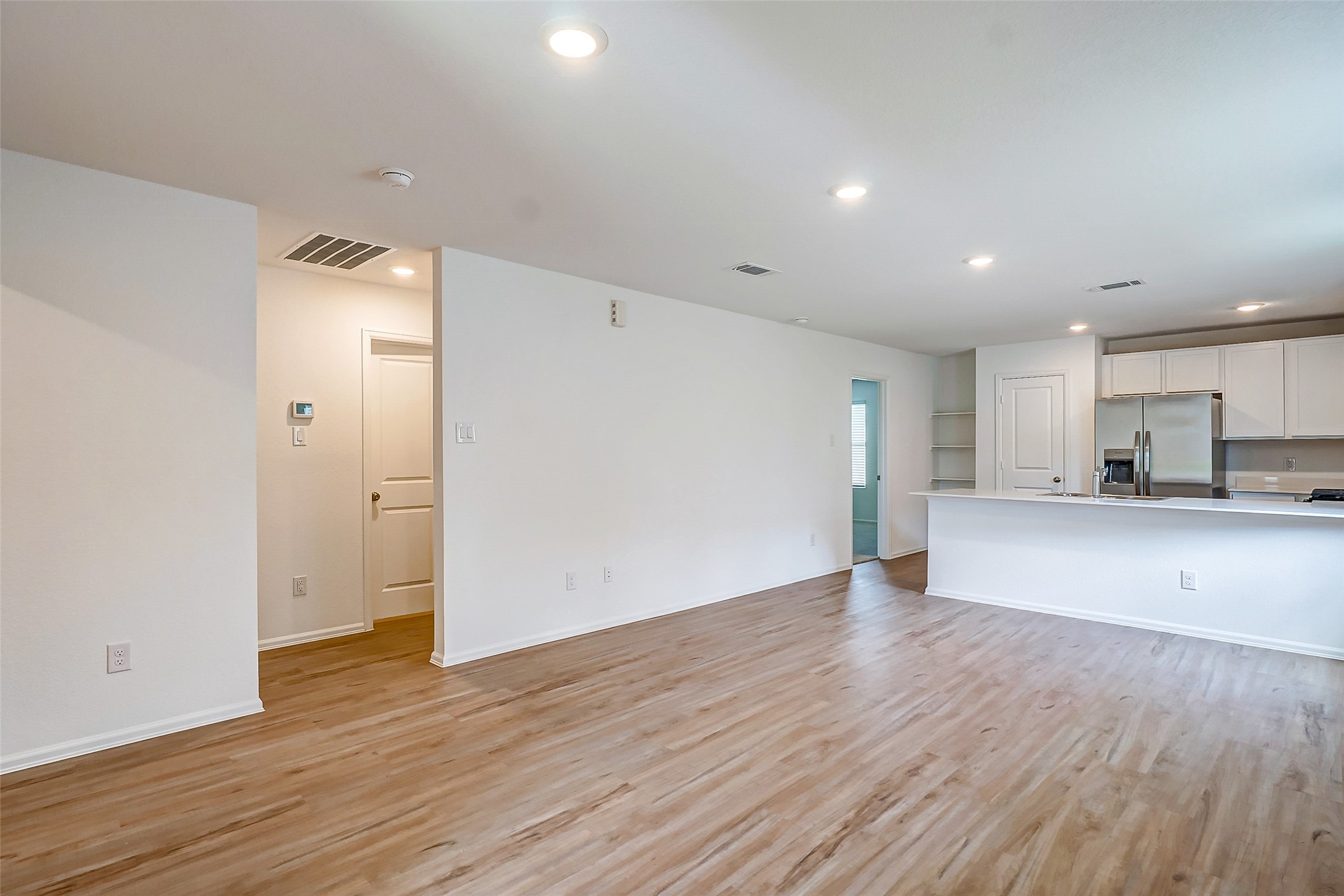 20961 Zuccala Drive New Caney, TX 77357 - Photo 6 of 33 a view of a kitchen with wooden floor and a sink