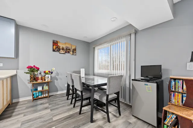a view of a dining room with furniture and a kitchen