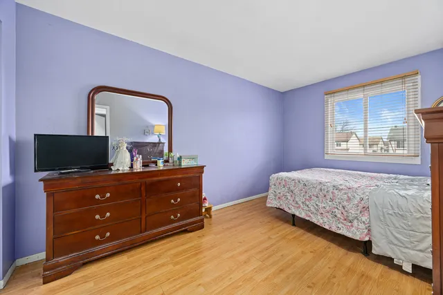 a bedroom with a bed and a television