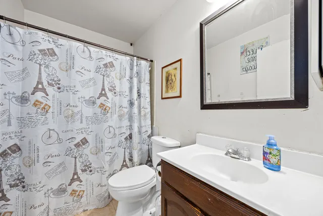 a bathroom with a sink toilet and a mirror