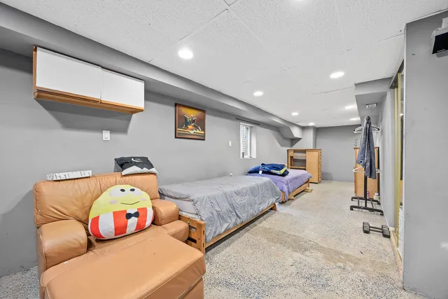 a bedroom with a bed and a couch