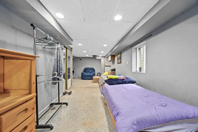 a bed room with a bed mirror and a window