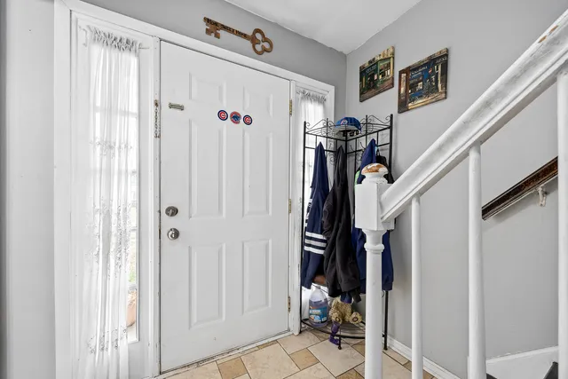 a view of a hallway with a white walls and stairs