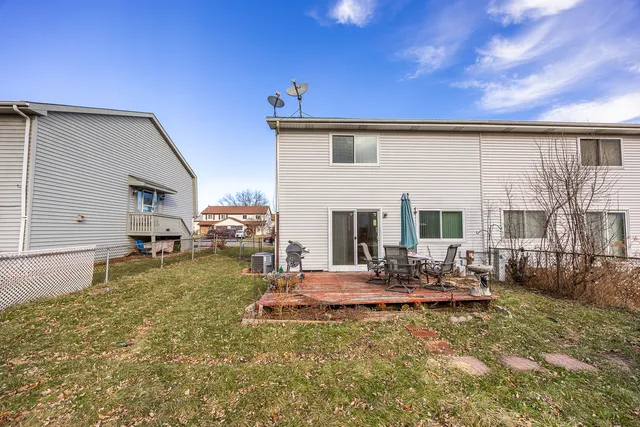 a view of a house with backyard porch and sitting area