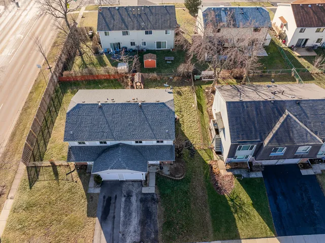 an aerial view of multiple houses with yard