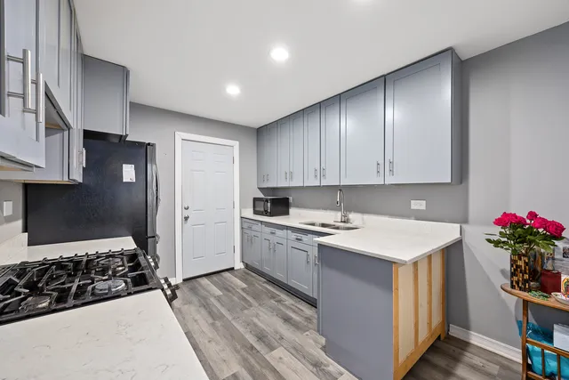 a kitchen with a sink stove and refrigerator