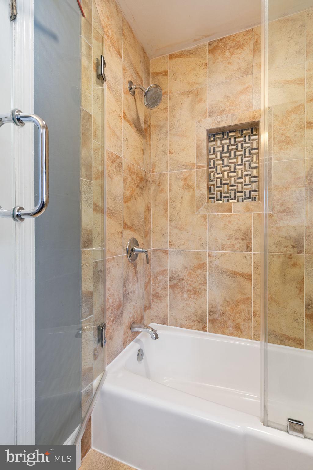 6102 Sherborn Lane Springfield, VA 22152 - Photo 36 of 51 a bathroom with a shower and a bath tub