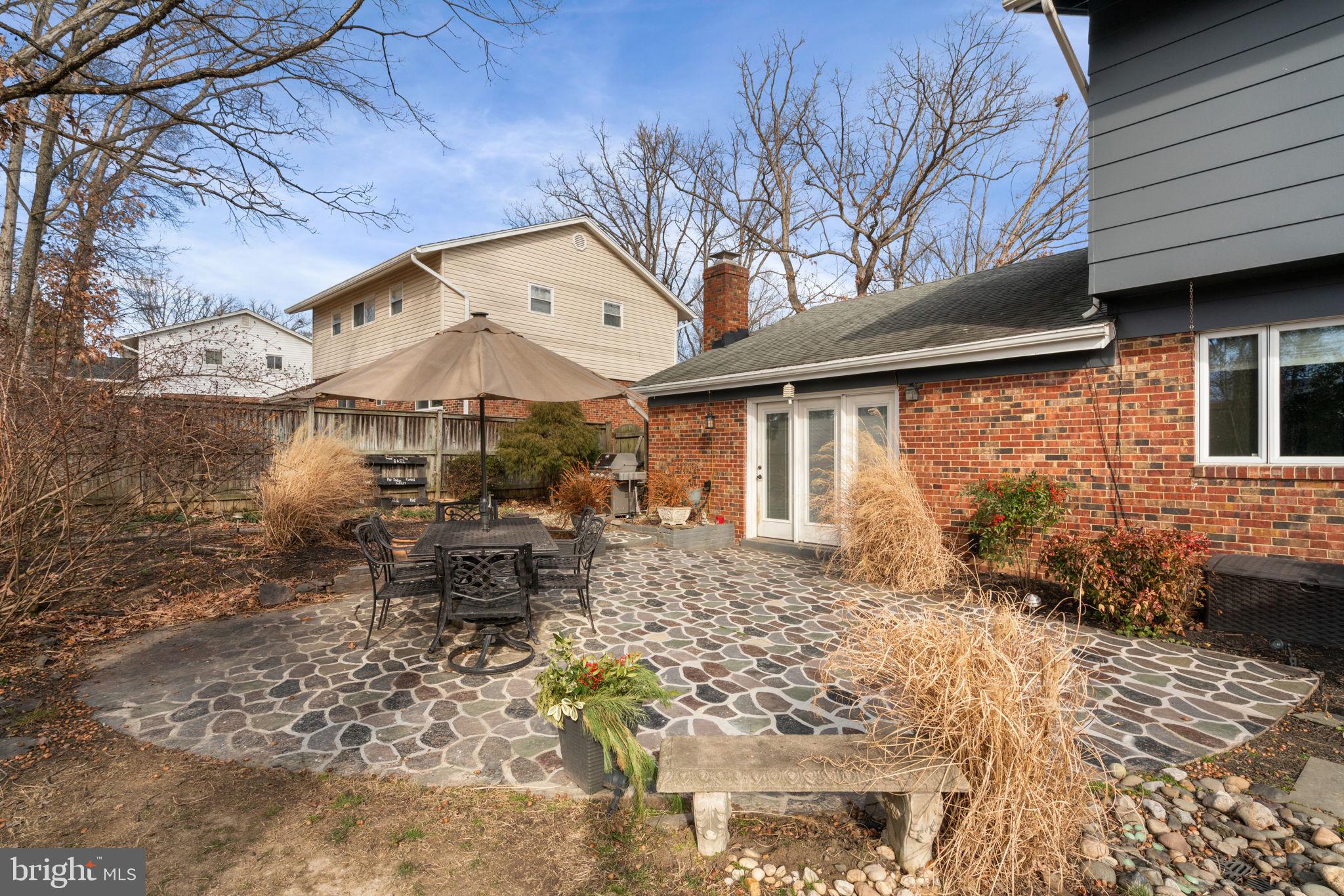 6102 Sherborn Lane Springfield, VA 22152 - Photo 38 of 51 a backyard of a house with yard and outdoor seating
