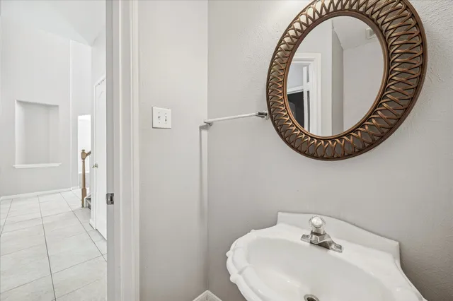 a bathroom with a sink and a mirror
