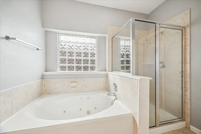 a bathroom with a bathtub and a shower