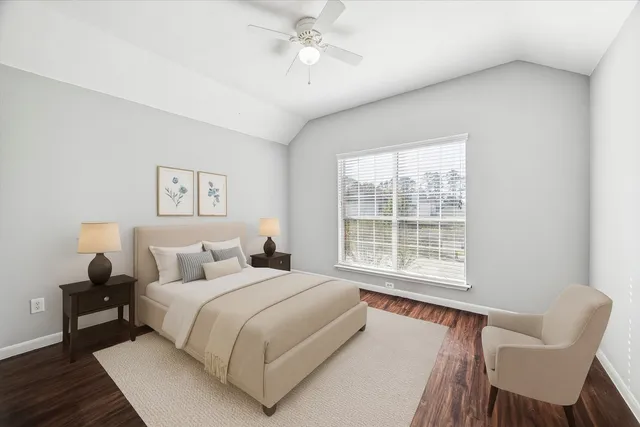 a bedroom with a bed and a chair