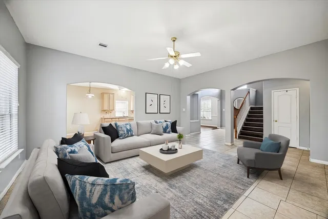 a living room with furniture and wooden floor
