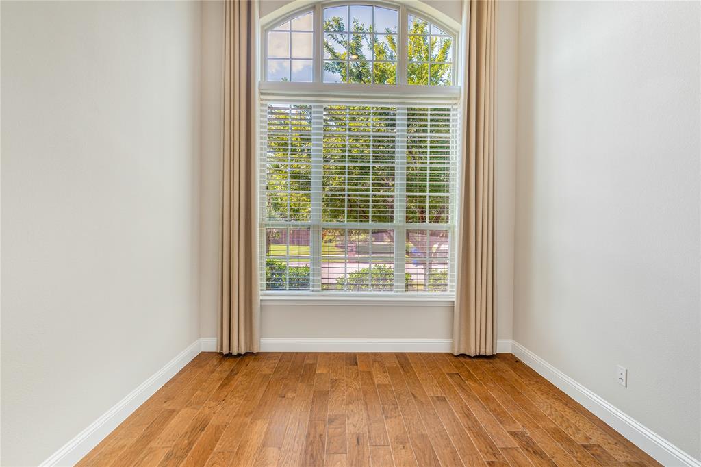 4560 Cheetah Trail Frisco, TX 75034 - Photo 17 of 38 a view of an empty room with wooden floor and a window