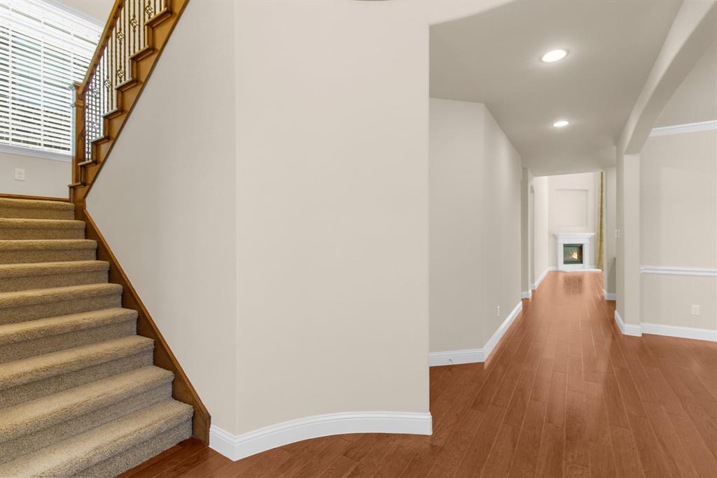4560 Cheetah Trail Frisco, TX 75034 - Photo 21 of 38 a view of a hallway with wooden floor and staircase