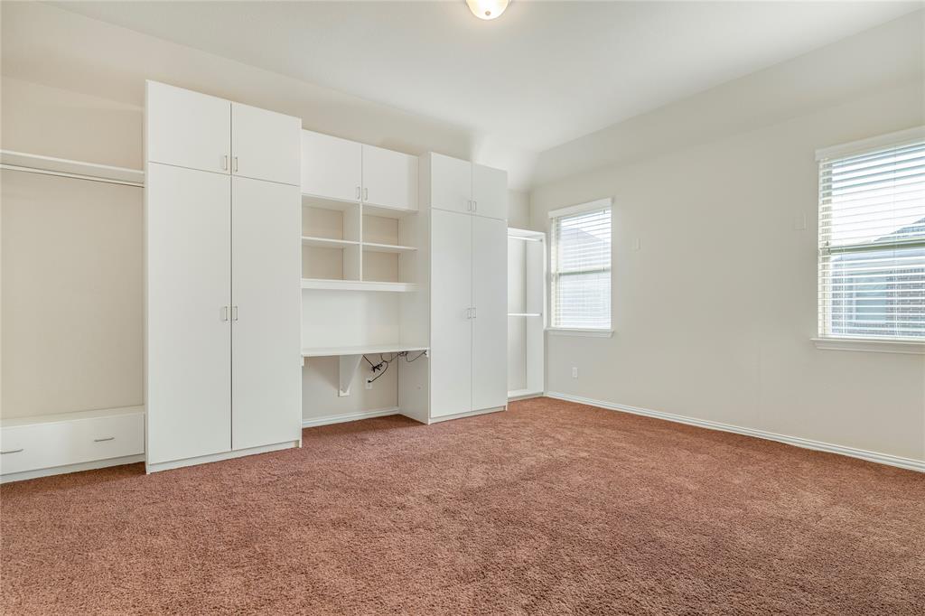 4560 Cheetah Trail Frisco, TX 75034 - Photo 28 of 38 an empty room with windows and cabinet