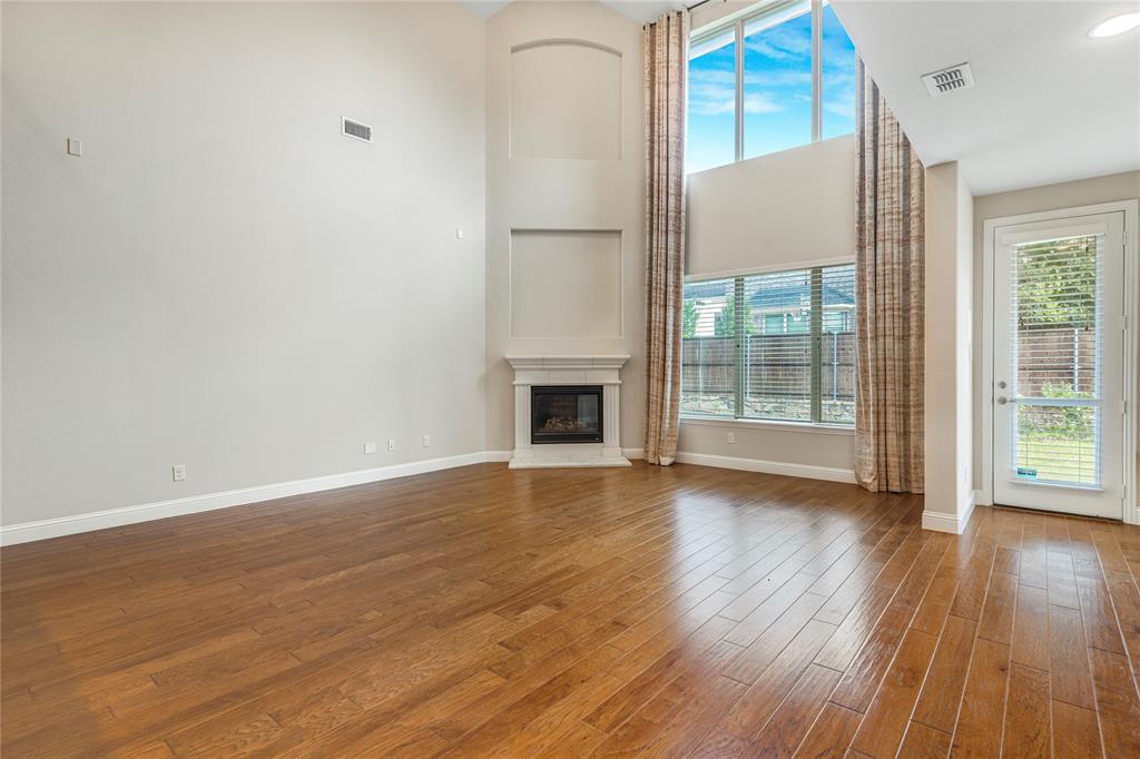 4560 Cheetah Trail Frisco, TX 75034 - Photo 5 of 38 a view of a livingroom with wooden floor and a fireplace
