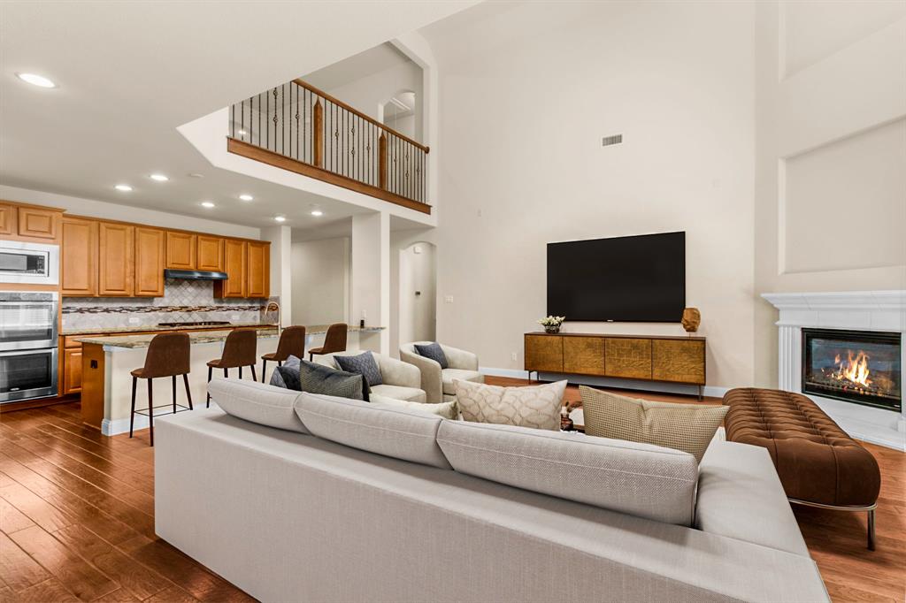 4560 Cheetah Trail Frisco, TX 75034 - Photo 7 of 38 a living room with furniture and a flat screen tv