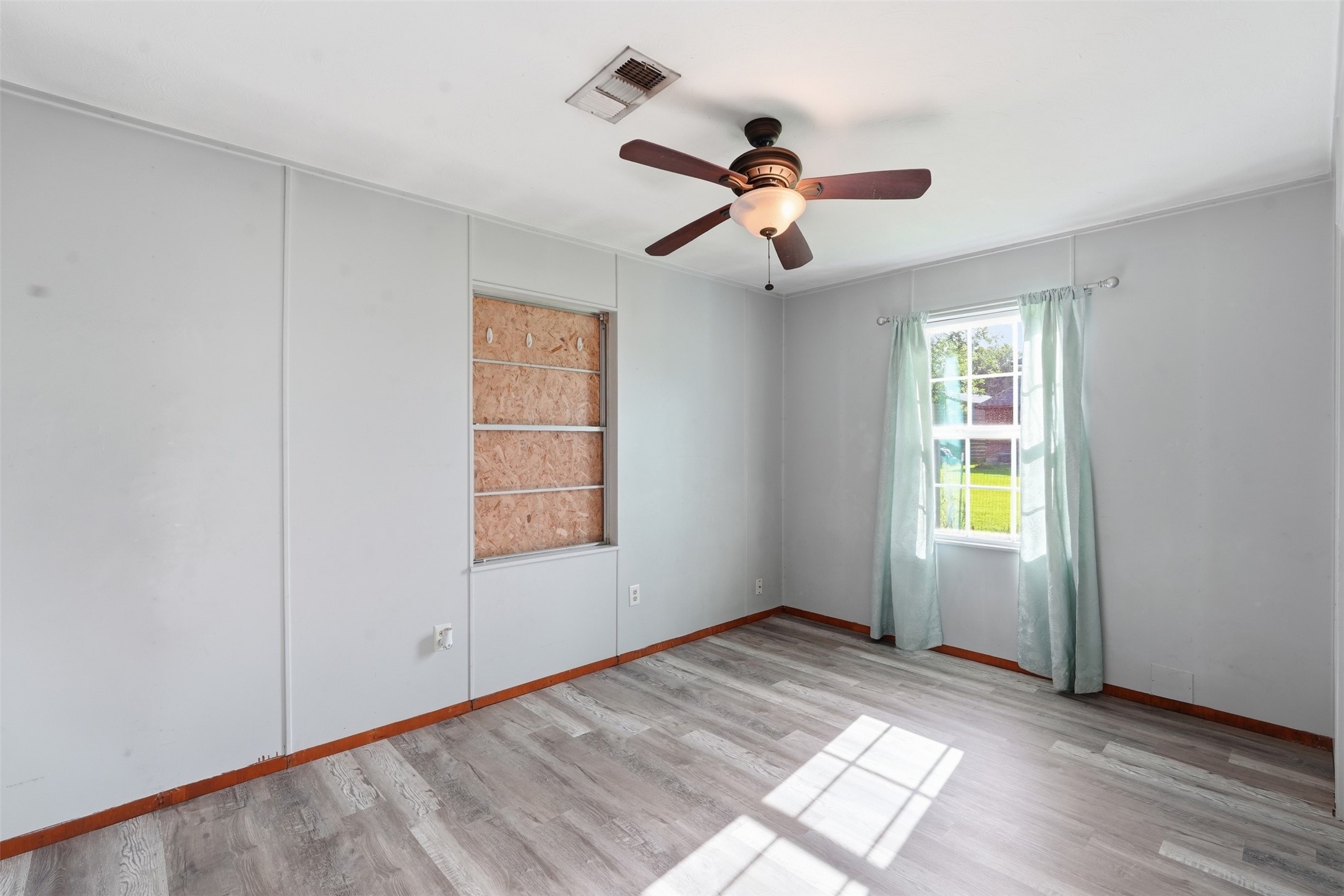 212 Jones Road Highlands, TX 77562 - Photo 13 of 24 a view of empty room with wooden floor and fan
