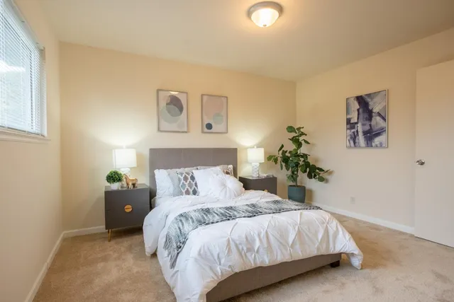 a bedroom with a bed and a night stand