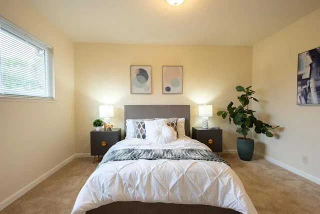 a view of a livingroom with furniture and a window