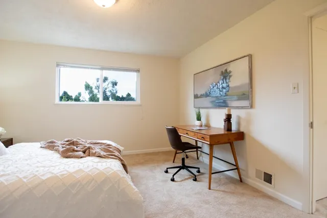 a bedroom with a bed and a window