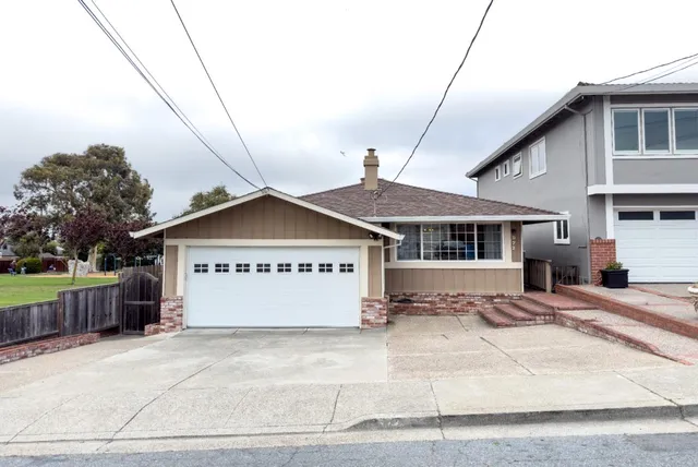 a view of a house with a wooden fence