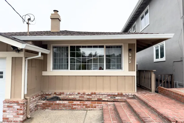 a front view of a house with a sitting area