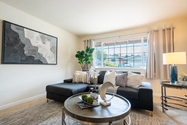 a living room with furniture and a large window