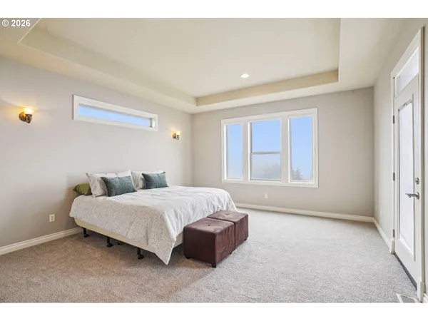 a spacious bedroom with a bed and a window
