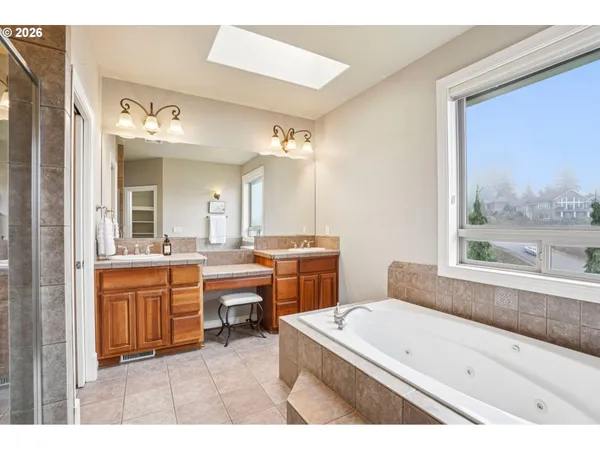 a bathroom with a tub sink and mirror